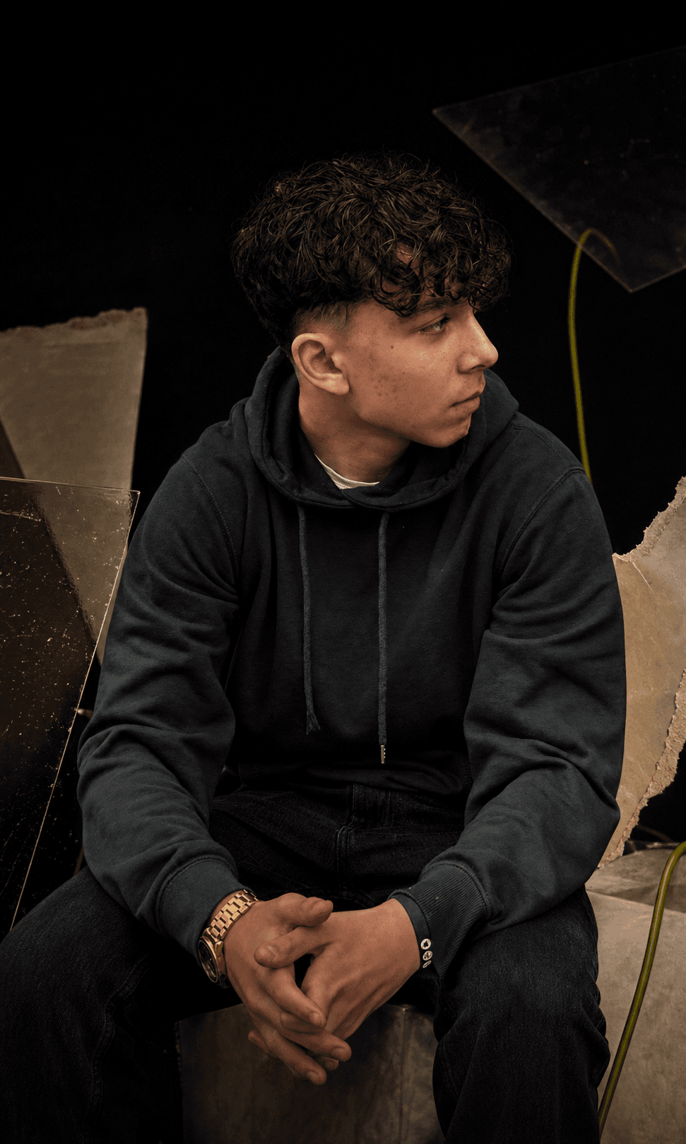Editorial portrait of Ezekiel in a dark studio setting